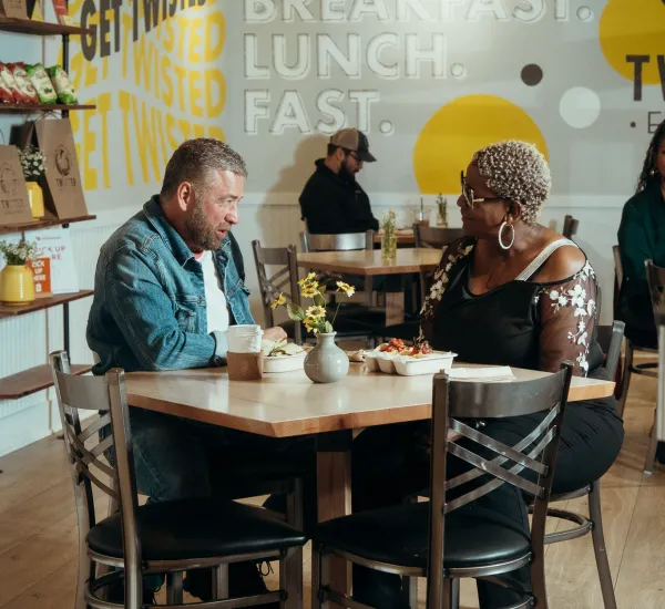 Two people enjoy breakfast at the twisted egg shack